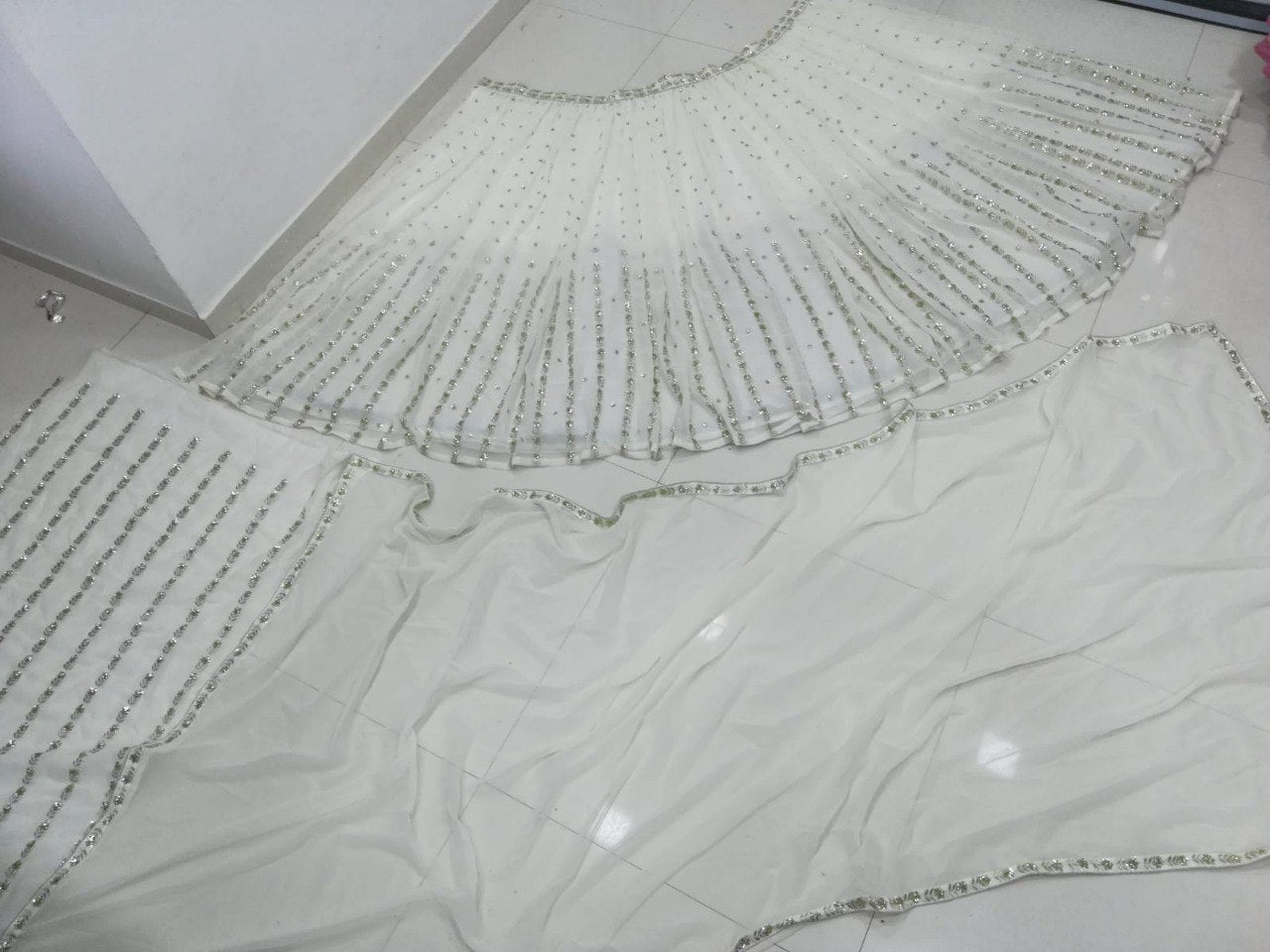 Graceful off-white sequence with zari embroidered georgette lehenga