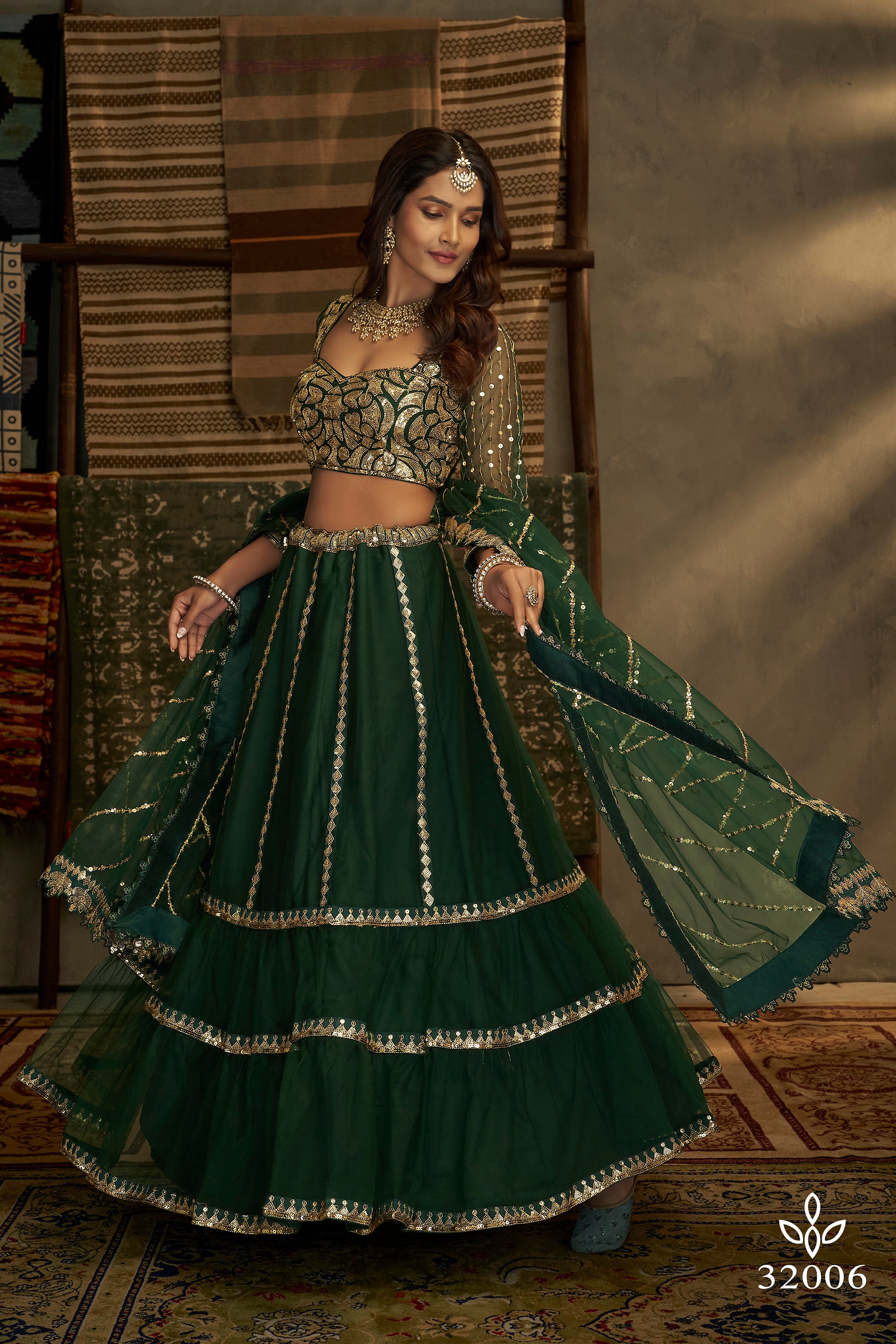 KISH MISH - YATEE : Double layered teal gherdar skirt intricately  embroidered with net flowers and paired with a dabka and resham jaal work  blouse adds an old world charm to the